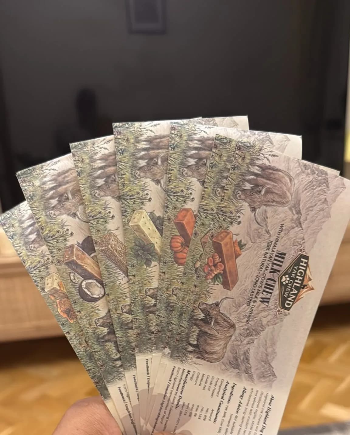 A hand fanning out five Highland Yak Chew Milk Chew packs — an easy dog stocking filler